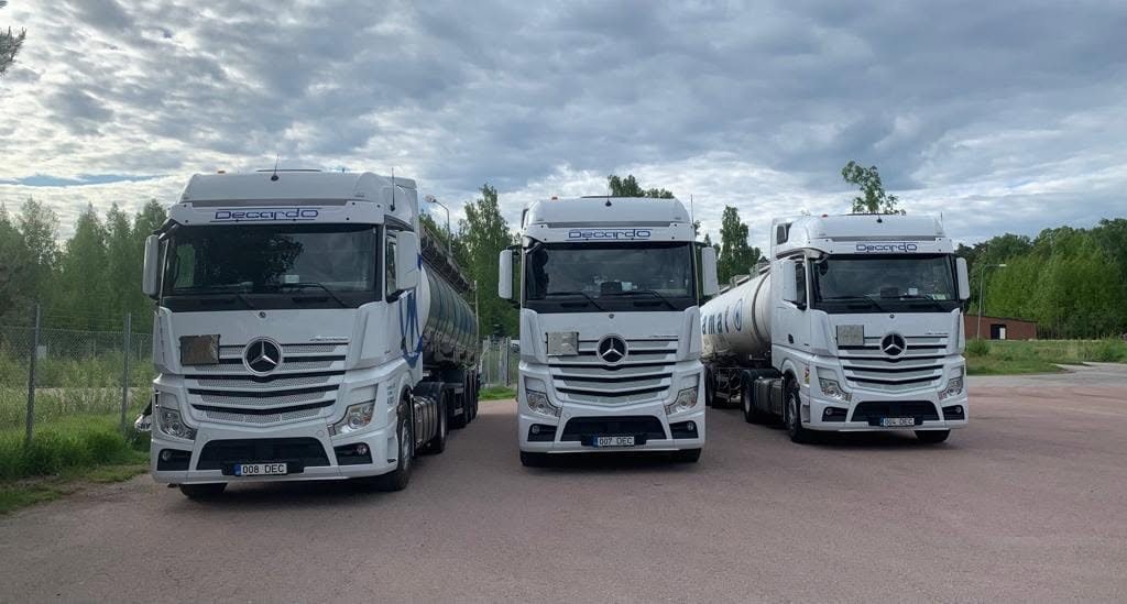 Three white Decardo tractor units with tank trailers