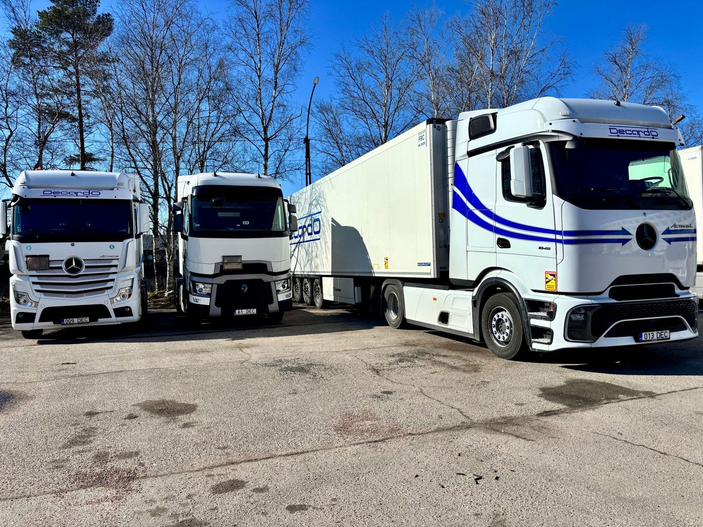 Three Decardo tractor units with semi-trailers parked side by side